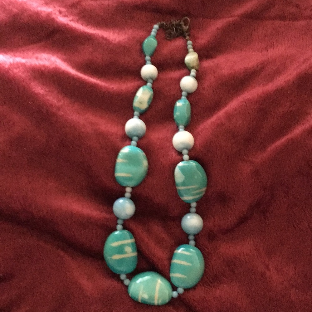 A blue rock necklace it’s about 12’ inches